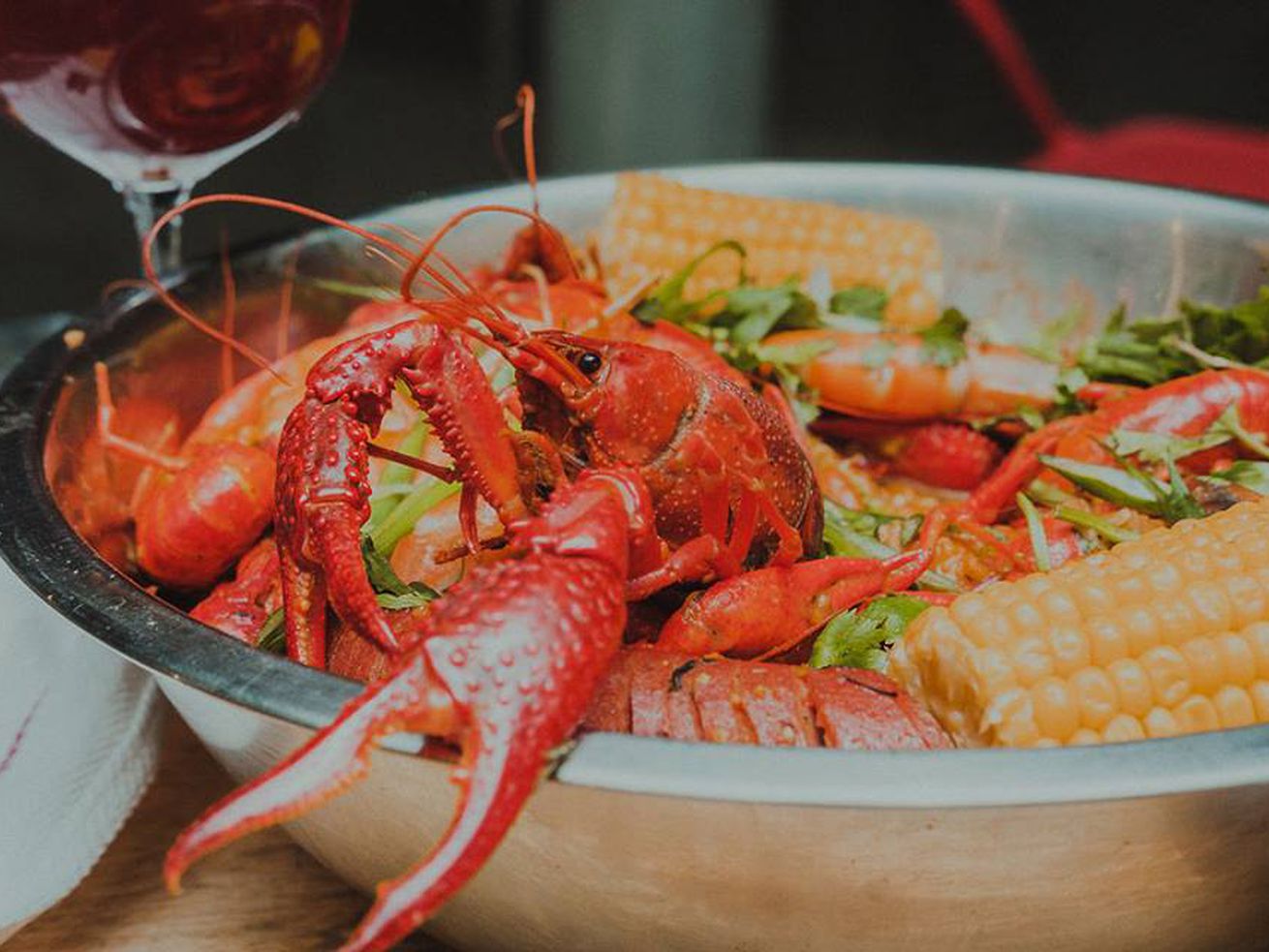 crawfish, sausage, and corn in silver bowl